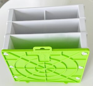 A plastic rack in white and green color on wall